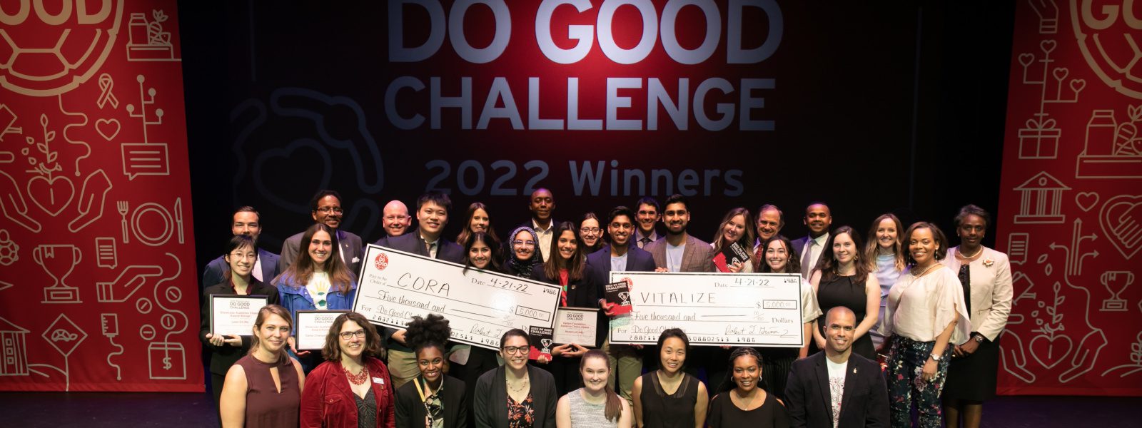 Group of Do Good Institute Challenge participants stand togther on a stage