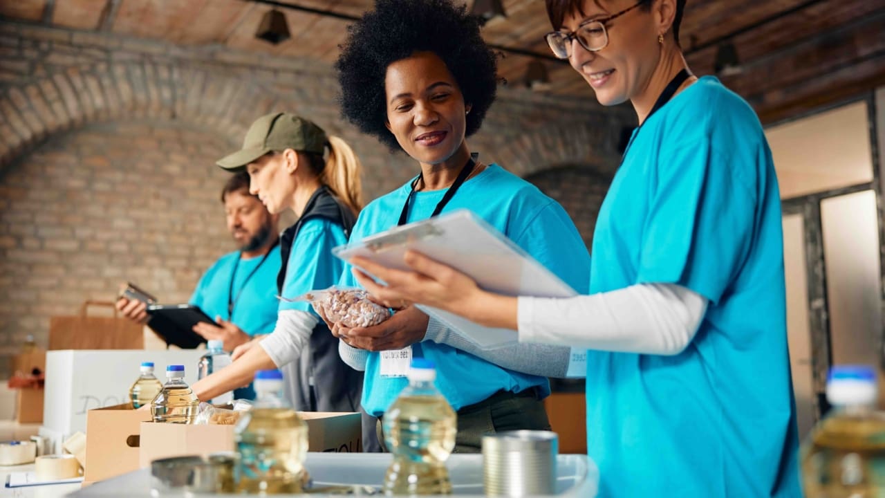 A group of volunteer workers pack donation boxes.
