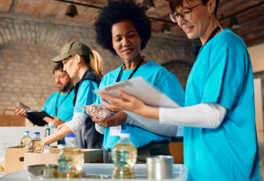 A group of volunteer workers pack donation boxes. A group of volunteer workers pack donation boxes.