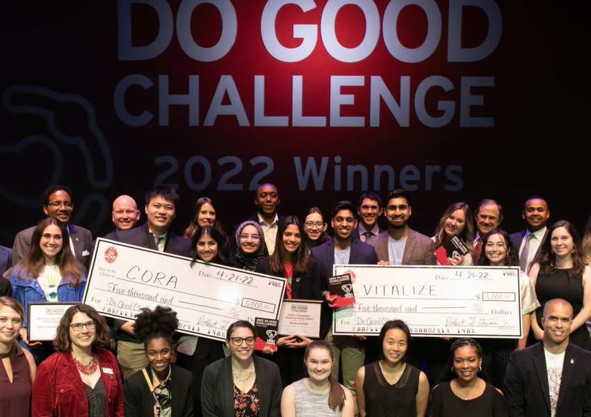 Group of Do Good Institute Challenge participants stand togther on a stage