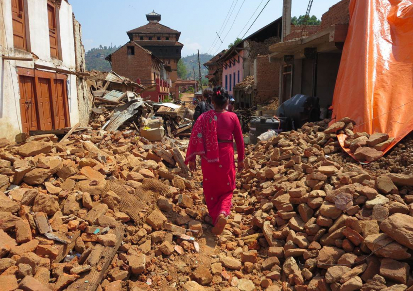 Just a few days after the rst earthquake, a local woman walks across debris in the Nuwakot Durbar.