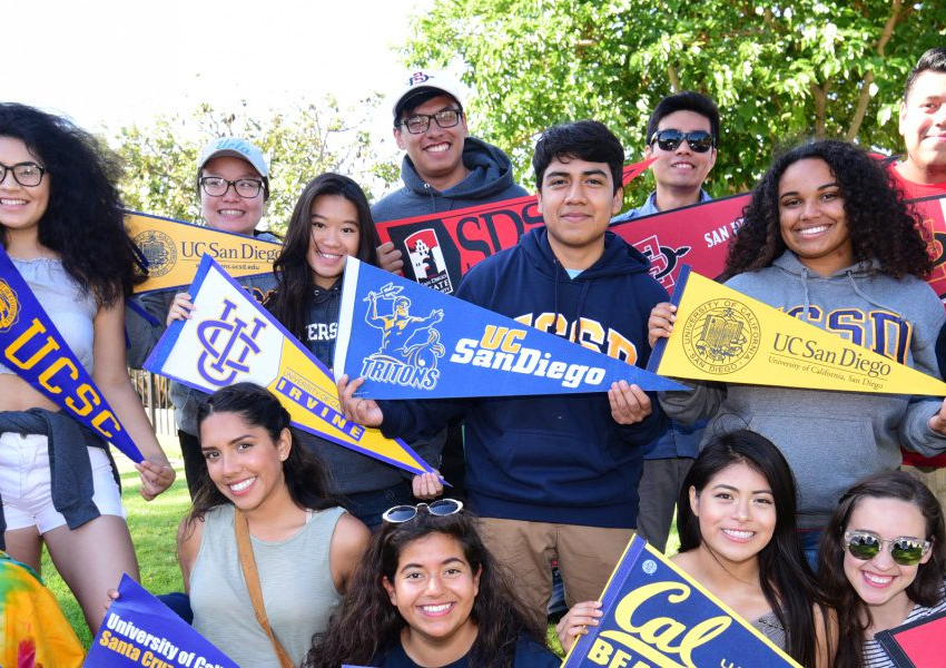 college students standing in group with college pennant